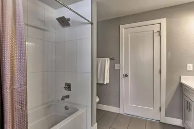a bathroom with a shower and a tub and a sink at Spacious and Quiet Retreat - Firepit and Yard in Denver