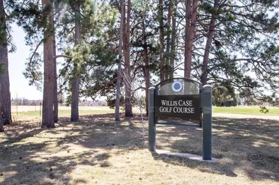 a sign in a park with trees in the background at Spacious and Quiet Retreat - Firepit and Yard in Denver