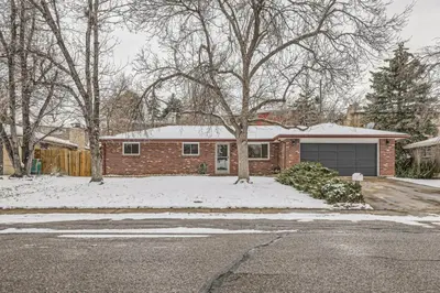 a brick house with a garage in the snow at Cozy Monthly 1BR near NREL & trails - 7th room 2 in Golden