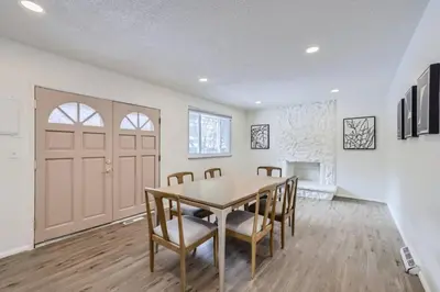 a dining room with a table and chairs and a door at Cozy Monthly 1BR near NREL & trails - 7th room 2 in Golden