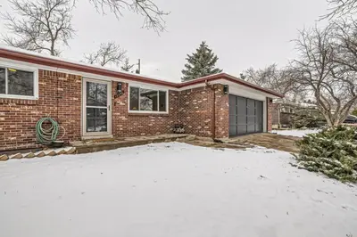 a brick house with a garage in the snow at Cozy Monthly 1BR near NREL & trails - 7th room 2 in Golden
