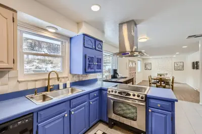 a kitchen with blue cabinets and a sink at Cozy Monthly 1BR near NREL & trails - 7th room 2 in Golden