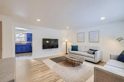 a living room with a couch and a table at Cozy Monthly 1BR near NREL & trails - 7th room 2 in Golden