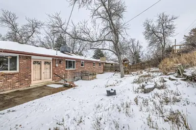 a house with a yard covered in snow at Cozy Monthly 1BR near NREL & trails - 7th room 2 in Golden