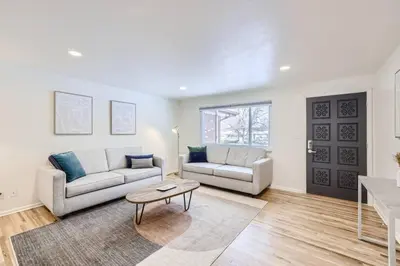 a living room with a couch and a table at Cozy Monthly 1BR near NREL & trails - 7th room 2 in Golden