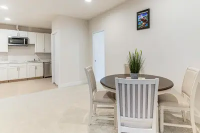 a kitchen and dining room with a table and chairs at 12 Mi to Hospitals Modern Apartment in Aurora! in Aurora