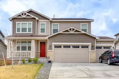 a house with a car parked in front of it at 12 Mi to Hospitals Modern Apartment in Aurora! in Aurora
