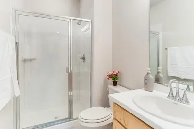 a bathroom with a shower and a toilet and a sink at 12 Mi to Hospitals Modern Apartment in Aurora! in Aurora