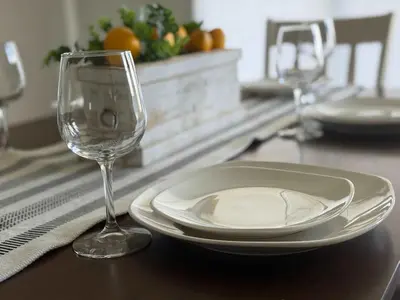 a plate and a wine glass on a table at Cozy Chasm Cottage in Loveland