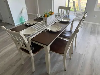 a dining room table with chairs and a table with wine glasses at Cozy Chasm Cottage in Loveland