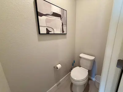 a bathroom with a toilet and a picture on the wall at Cozy Chasm Cottage in Loveland