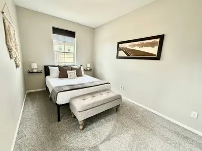 a bedroom with a bed and a bench in it at Cozy Chasm Cottage in Loveland