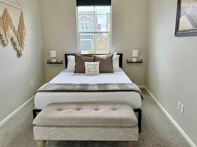 a bedroom with a large bed and a window at Cozy Chasm Cottage in Loveland