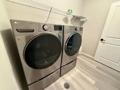 a silver washing machine in a room with a floor at Cozy Chasm Cottage in Loveland