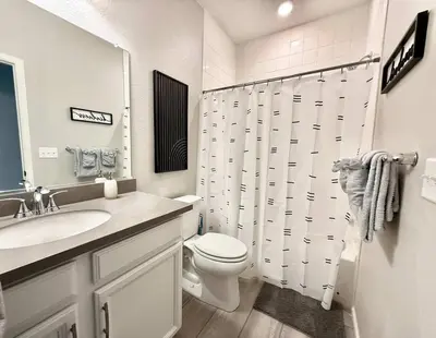 a white bathroom with a toilet and a sink at Cozy Chasm Cottage in Loveland