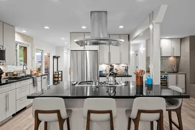 a kitchen with a black counter top and white cabinets at 1010 Rosehill Dr in Boulder