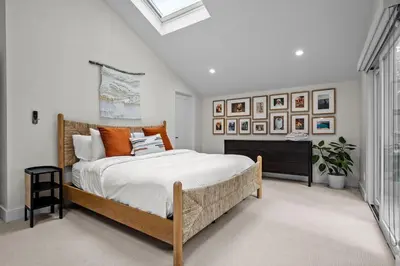 a bedroom with a large bed with orange pillows at 1010 Rosehill Dr in Boulder