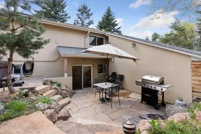 a patio with an umbrella and a grill at 1010 Rosehill Dr in Boulder