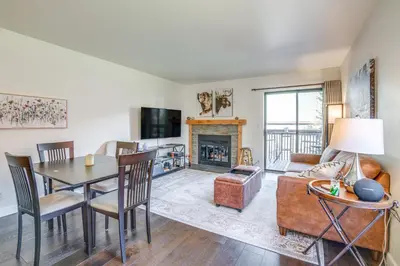 a living room with a table and a fireplace at half Mi to Dtwn Frisco Mtn-View Condo with Pool! in Frisco
