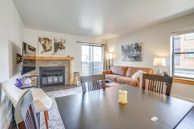 a living room with a table and a couch at half Mi to Dtwn Frisco Mtn-View Condo with Pool! in Frisco