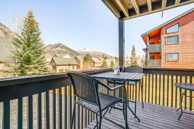 a patio with a table and chairs on a balcony at half Mi to Dtwn Frisco Mtn-View Condo with Pool! in Frisco