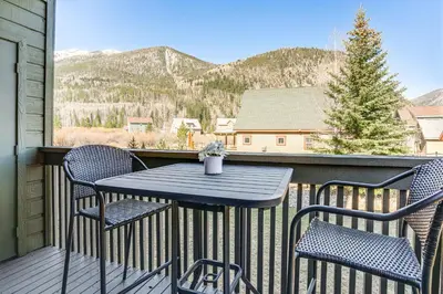 a table and chairs on a balcony with mountains at half Mi to Dtwn Frisco Mtn-View Condo with Pool! in Frisco