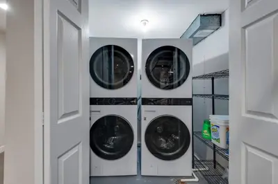 three washing machines are in a laundry room at Mid Summer Night's Dream w/HotTub&Theater in Arvada