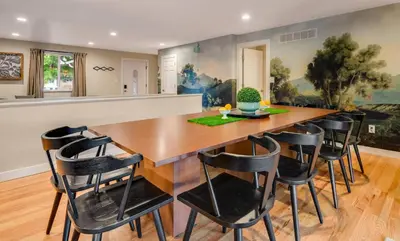 a dining room with a large wooden table and chairs at Mid Summer Night's Dream w/HotTub&Theater in Arvada