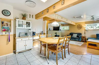 a kitchen and living room with a table and chairs at Near Family-Friendly Attractions Northglenn Home! in Northglenn