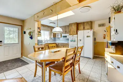 a kitchen with a wooden table and chairs at Near Family-Friendly Attractions Northglenn Home! in Northglenn