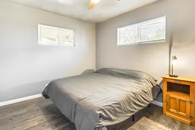 a bedroom with a bed and two windows at Near Family-Friendly Attractions Northglenn Home! in Northglenn