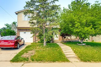 a red car parked in front of a house at Near Family-Friendly Attractions Northglenn Home! in Northglenn
