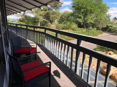 two chairs on a porch with a view of a street at Unique Home 40 acres Peaceful Near Boulder 2 Dogs OK in Longmont