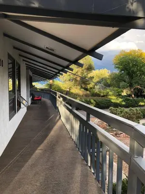 a covered walkway with a bench on the side of a building at Unique Home 40 acres Peaceful Near Boulder 2 Dogs OK in Longmont