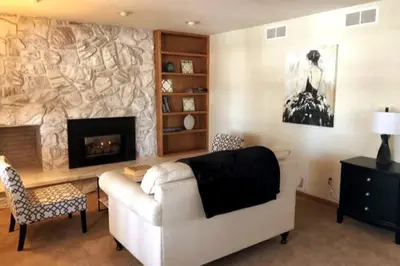 a living room with a white couch and a fireplace at Large Home Near Boulder Fenced Yard 2 Dogs OK in Longmont