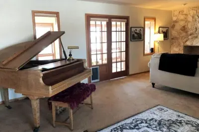 a living room with a piano and a couch at Large Home Near Boulder Fenced Yard 2 Dogs OK in Longmont