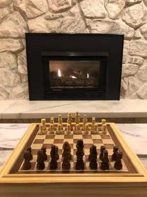 a chessboard on a table in front of a fireplace at Large Home Near Boulder Fenced Yard 2 Dogs OK in Longmont