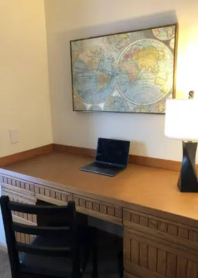 a laptop on a desk with a map on the wall at Large Home Near Boulder Fenced Yard 2 Dogs OK in Longmont