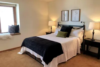 a bedroom with a bed with two lamps and a window at Large Home Near Boulder Fenced Yard 2 Dogs OK in Longmont