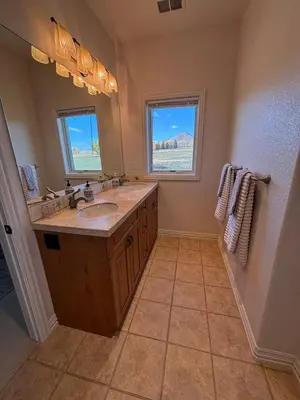 a bathroom with a large sink and two windows at A Peaceful Slice of Heaven Near Boulder in Niwot