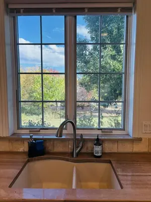 a kitchen sink in front of a large window at A Peaceful Slice of Heaven Near Boulder in Niwot
