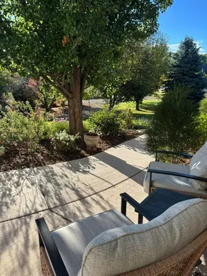 a patio with two chairs and a couch on a sidewalk at A Peaceful Slice of Heaven Near Boulder in Niwot
