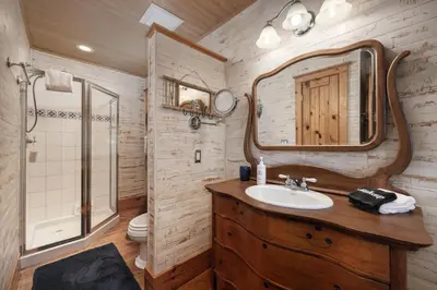 a bathroom with a sink and a mirror at West Portal Cabin cabin in Grand Lake