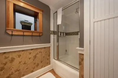 a bathroom with a shower and a window at West Portal Cabin cabin in Grand Lake