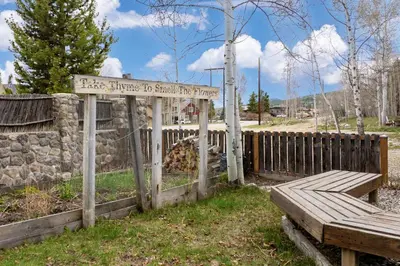 a wooden fence with a sign that reads first steps to start the process at West Portal Cabin cabin in Grand Lake