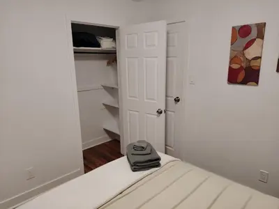 a white bedroom with a bed with a hat on it at Home with Garden 3BR Perfect Family & Groups in Denver