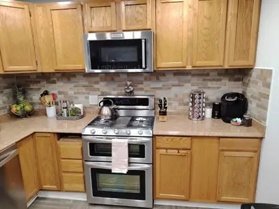 a kitchen with a stove and a microwave at Home with Garden 3BR Perfect Family & Groups in Denver