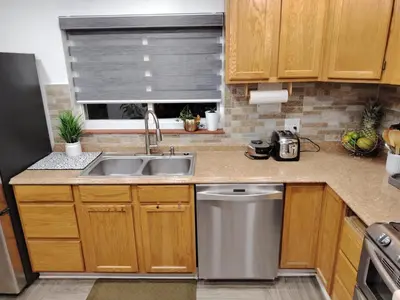 a small kitchen with a sink and a dishwasher at Home with Garden 3BR Perfect Family & Groups in Denver