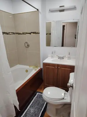a bathroom with a toilet and a tub and a sink at Home with Garden 3BR Perfect Family & Groups in Denver