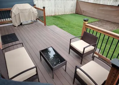 a wooden deck with chairs and a table and a table at Home with Garden 3BR Perfect Family & Groups in Denver